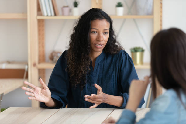 fermez-vous vers le haut femme d’affaires afro-américaine confiante expliquant de nouvelles responsabilités. - unsmiling photos et images de collection