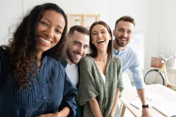 Photo of Close up headshot portrait picture of diverse team taking selfie.