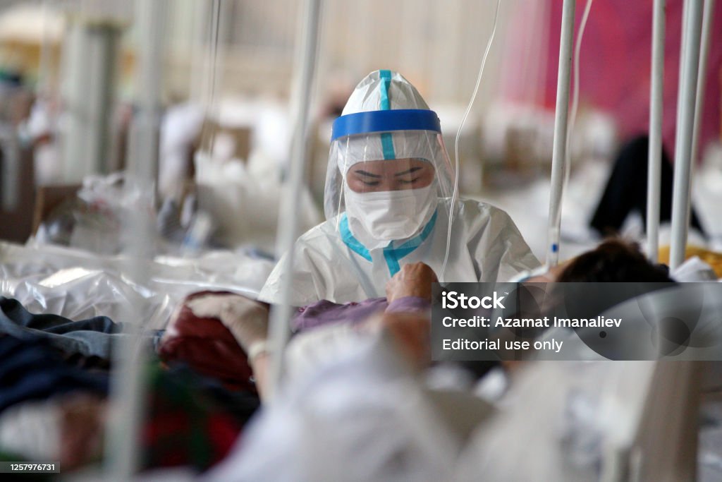 The temporary hospital converted from Palace of Sport designated to treat the COVID-19 patients in Bishkek, Kyrgyzstan A medical professional work in the temporary Covid-19 care center in Bishkek, on Jule 8, 2020. Coronavirus Stock Photo