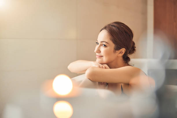 istock Smiling lady daydreaming in a hydromassage bath 1257979431