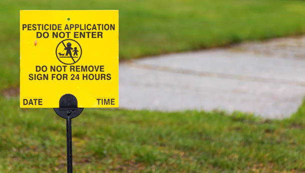 Pesticides just applied sign on a lawn A yellow sign place on a residential lawn reads Pesticide applicatiion, do not enter for 24 hours. apply fertilizer stock pictures, royalty-free photos & images