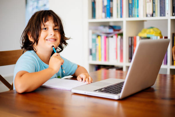 istock Little boys attending to online school class 1257981655