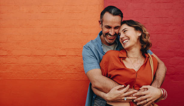 istock Romantic couple together on multicolored wall 1257983568