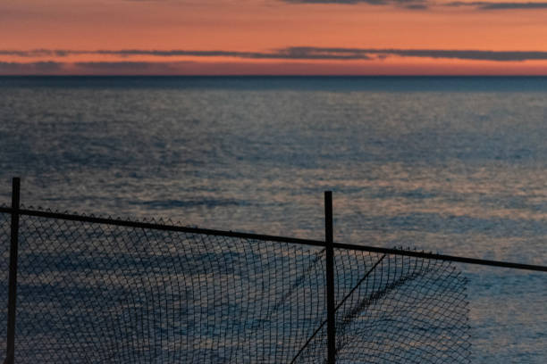 istock Fence in front of Lake Erie Sunset 1257985435