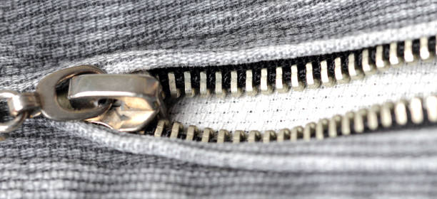 istock Zipper on gray denim close-up, wide view. Flat lay, top view, copy space. 1257985520