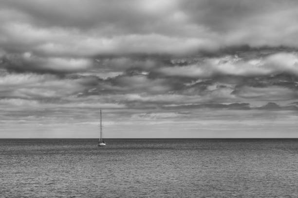 Minimalist fine art photograph of a yacht in Portmellon bay in Cornwall.
