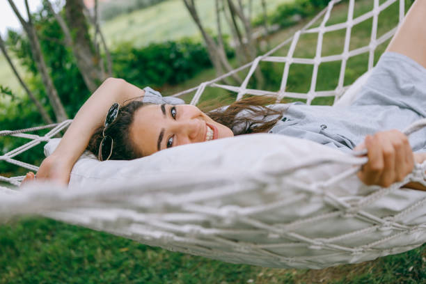 istock Young woman in hammock smiling at camera 1257991674