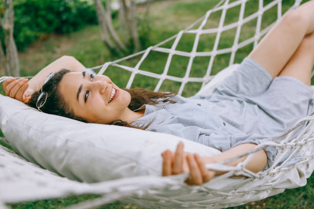 istock young woman in hammock smiling 1257991968