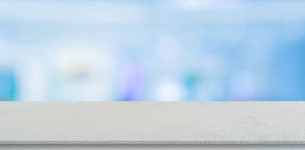istock blurred inside of interior modern bathroom in the morning background with white concrete tabletop for show, promote ads and design product on display concept 1257993386