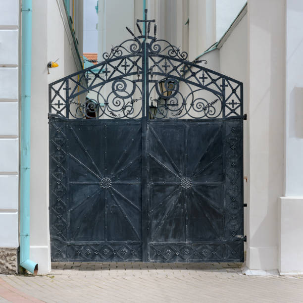 istock black iron wrought closed gate entrance to urban cemetery front view 1257995965