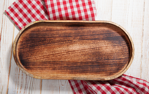 Empty pizza board on white wooden table. Empty tray. Mockup for design. Top view. Maximum sharpness