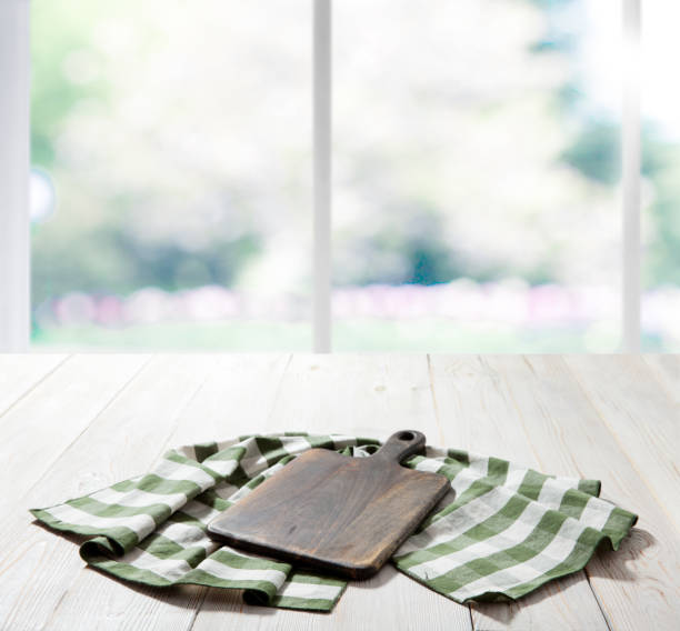 istock Empty pizza board and table cloth on wooden deck table with napkin. Kitchen background. 1258001137