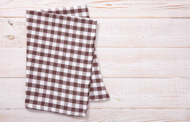 istock Tablecloth napkin on wood texture. Rustic background. top view. 1258001139