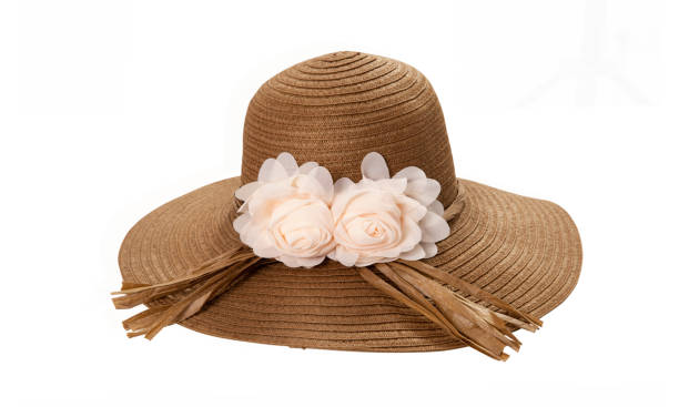 istock Pretty straw hat with ribbon and bow on white background. Beach hat top view isolated 1258002353