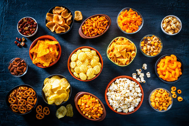 istock Salty snacks assortment shot from above on dark slate table 1258002396