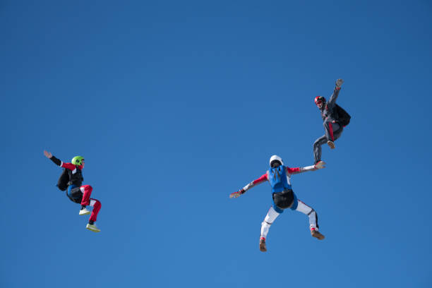 istock Freefall jumpers soar above mountain landscape 1258002423