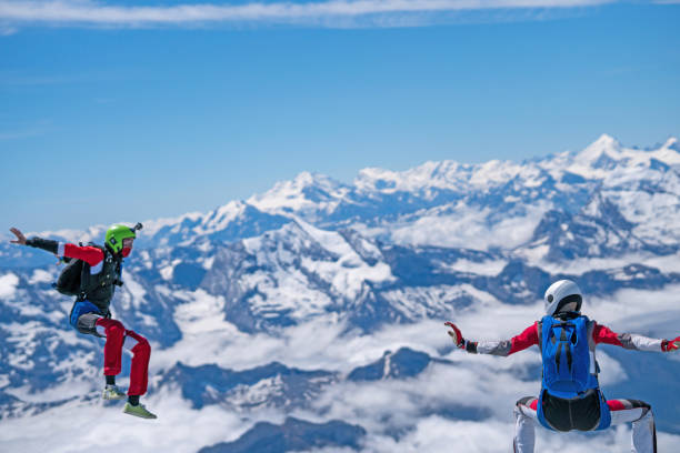 istock Freefall jumpers soar above mountain landscape 1258002748