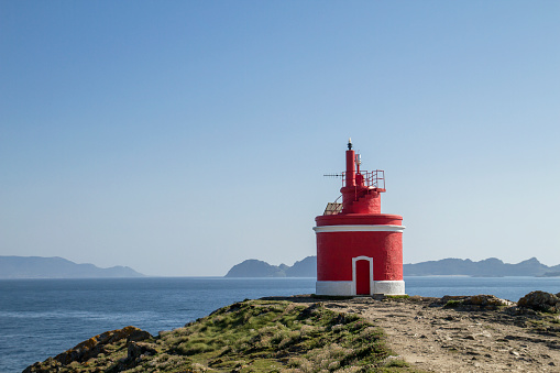 Red lighthouse in Punta Robaleira, Costa da Vela, Pontevedra, Spain