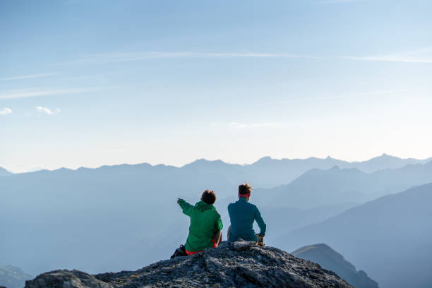 istock Female hikers relax on mountain ridge 1258005830
