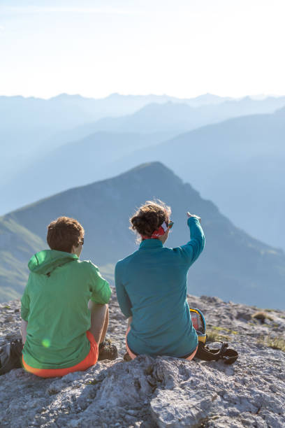 istock Female hikers relax on mountain ridge 1258005904