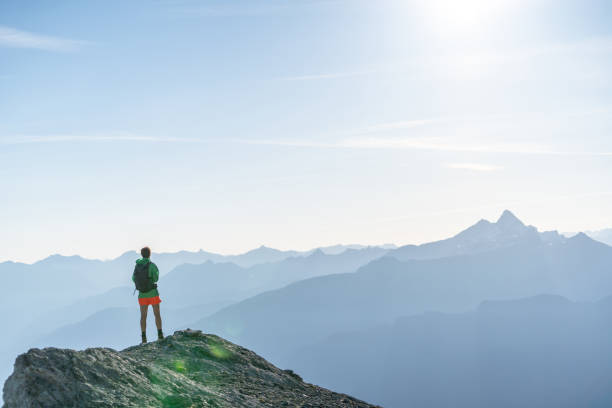 istock Female hiker relaxes on mountain ridge 1258006008