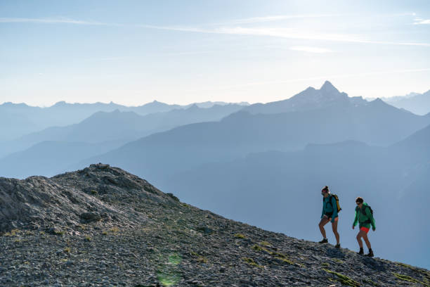 istock Female hikers walk along mountain ridge 1258006678
