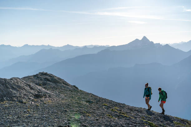 istock Female hikers walk along mountain ridge 1258006705