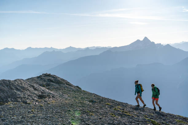 istock Female hikers walk along mountain ridge 1258006811