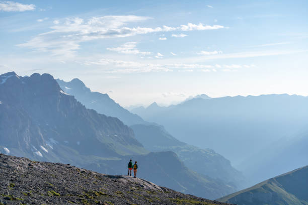 istock Female hikers walk along mountain ridge 1258006952