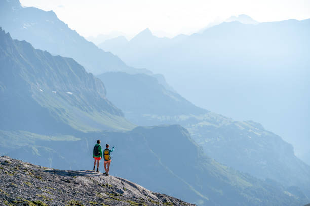 istock Female hikers walk along mountain ridge 1258007030
