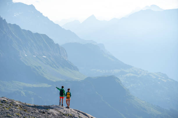 istock Female hikers walk along mountain ridge 1258007031