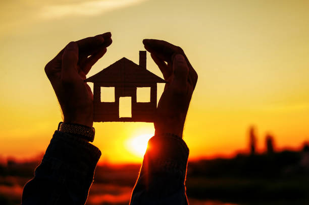 istock real estate agent holding house 1258009386