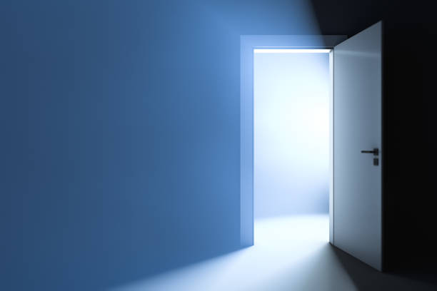 istock Bright light behind the slightly ajar door. Abstract background. 1258009388