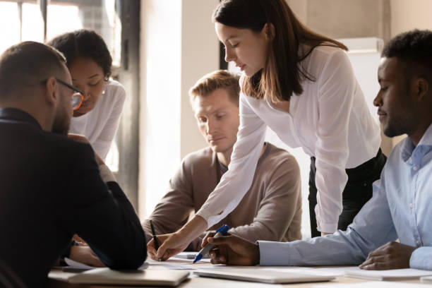 istock Multiracial diverse businesspeople cooperating at office meeting 1258010062