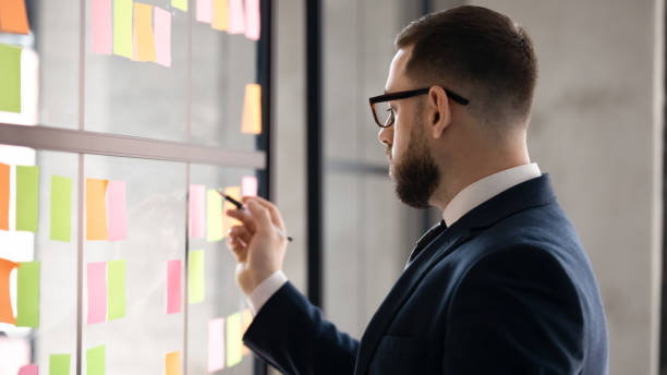 istock Male employee engaged in creative thinking in office 1258010159