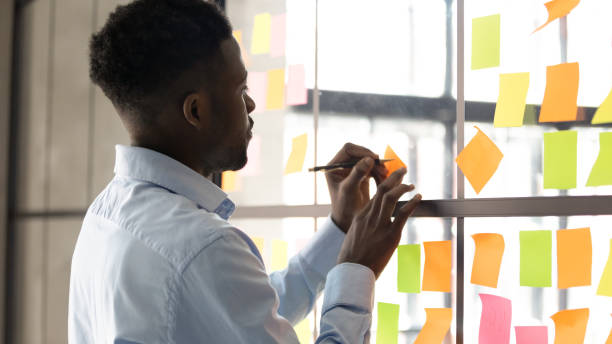 istock Focused biracial employee engaged in creative thinking at workplace 1258010163