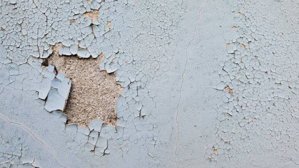 istock Grunge texture of blue peeling paint on grey stone wall 1258012934