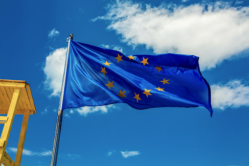 United Kingdom and European Union twin flags waving flags on textured background