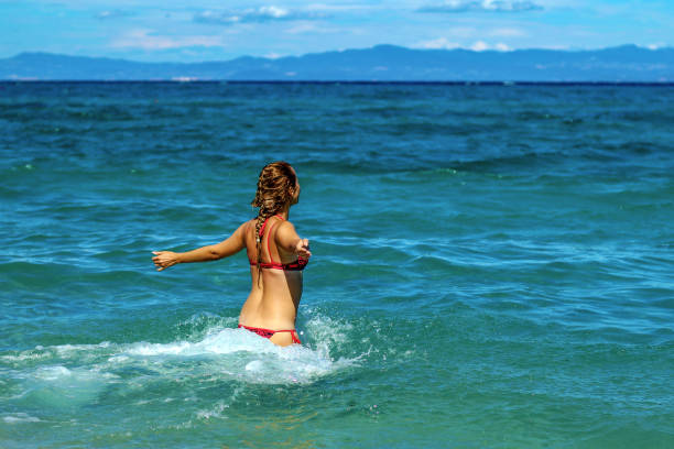 istock Young Woman enjoying a day at the beach 1258014033