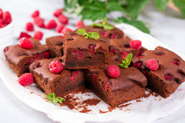 istock Brownie pieces with raspberries on gray background decorated with berries 1258017087