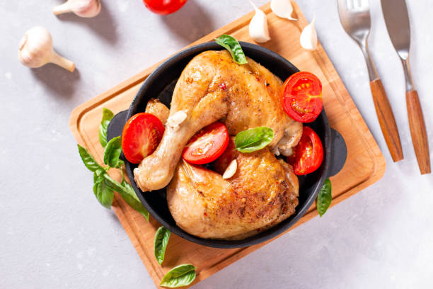 istock Chicken Legs with garlic on bright gray background. Top view. 1258017095