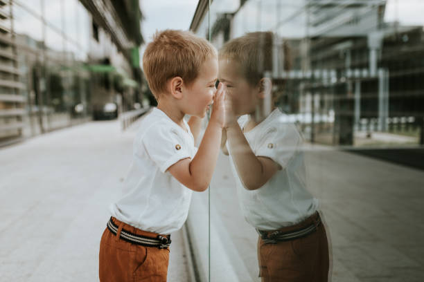 istock Young boy and his reflection on glass 1258019278