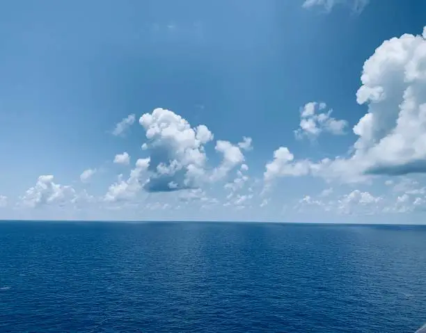 Clouds over an open blue ocean