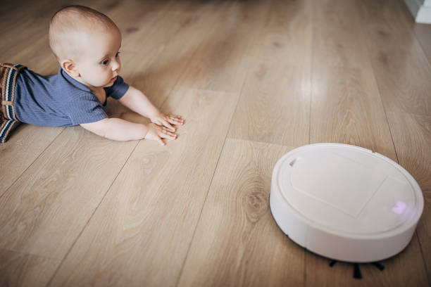 istock One baby boy discovering robotic vaccum cleaner 1258022682