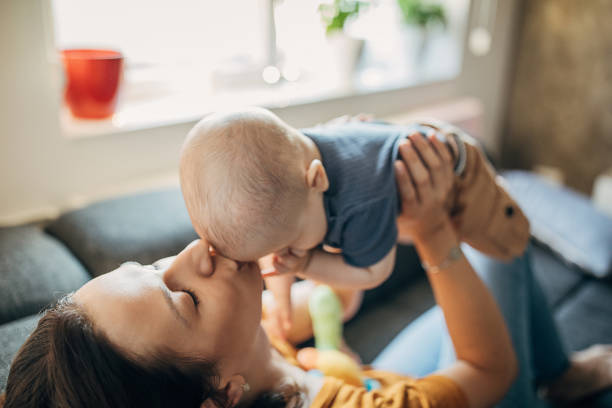 istock Mother playing with her little boy on sofa at home 1258023885