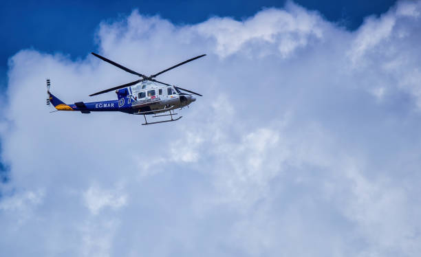 Ronda, Spain - September 06, 2015: A spanish FAASA Bell 412 EC-MAR flying over Ronda against cloudy sky