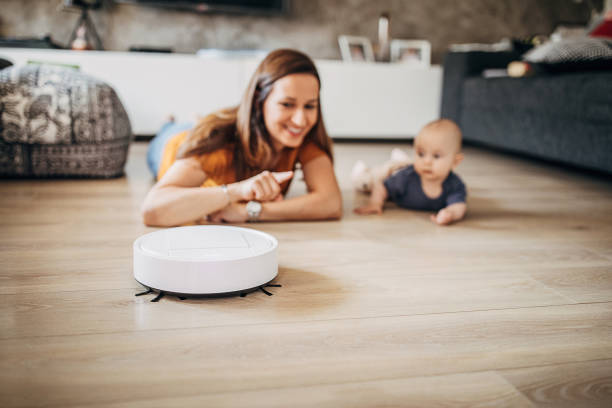 istock Mother and son discovering robotic vacuum cleaner 1258024137