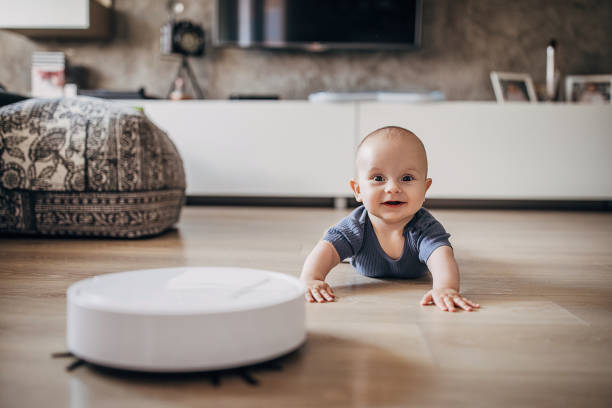 istock Cute baby boy discovering robotic vaccum cleaner 1258024911