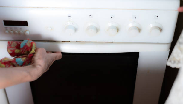 istock Opening the oven by hand 1258026966