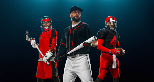 Group of athletes. Professional american football player in helmet with ball, lacrosse player with stick, and baseball player with bat. Sport and motivation wallpaper. stock photo